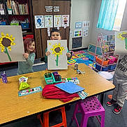 Davina joined the competition — help win amazing prizes! artwork, bookshelf, child, children, classroom, colorful, craft, education, indoor, kids, learning, numbers, paper, playful, poster, school, smiling, stool, sunflower, table