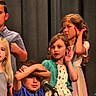 audience, blonde_hair, brown_hair, child, children, curtain, dress, event, expression, fun, group, indoor, microphone, people, performance, playful, posing, shirt, stage, young