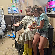 Davina joined the competition — help win amazing prizes! birthday_bag, caregiving, chair, child, colorful_socks, denim_shorts, family, girl, heart_monitor, hospital, hospital_bed, infusion_pump, iv_bag, iv_pole, medical_equipment, medical_room, patient, sitting, striped_shirt, water_bottle