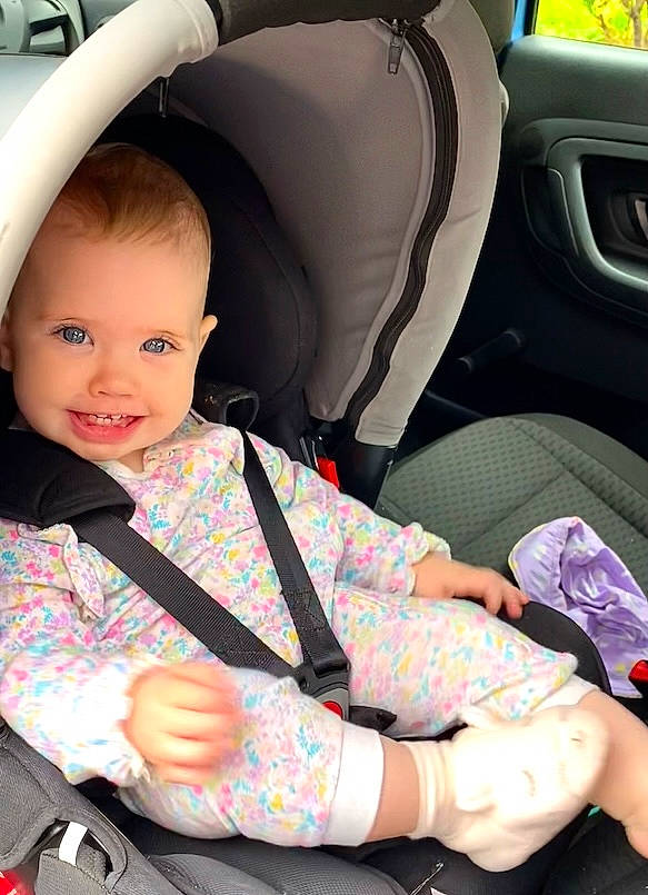 Aura is registered to the contest to win money with this photo: auto_part, automotive_design, automotive_exterior, baby_carriage, baby_in_car_seat, baby_toddler_clothing, car_seat, car_seat_cover, comfort, finger, hand, head_restraint, joy, lap, motor_vehicle, person, seat_belt, smile, steering_part, steering_wheel