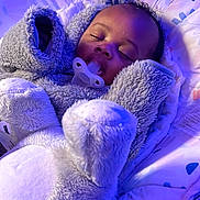 Cylas is registered to the contest to win money with this photo: baby, sleeping, pacifier, onesie, plush, cushion, infant, cozy, child, indoor, soft, cute, comfort, peaceful, face, head, clothing, rest, purple_light, bed