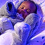 baby, sleeping, pacifier, onesie, plush, cushion, infant, cozy, child, indoor, soft, cute, comfort, peaceful, face, head, clothing, rest, purple_light, bed