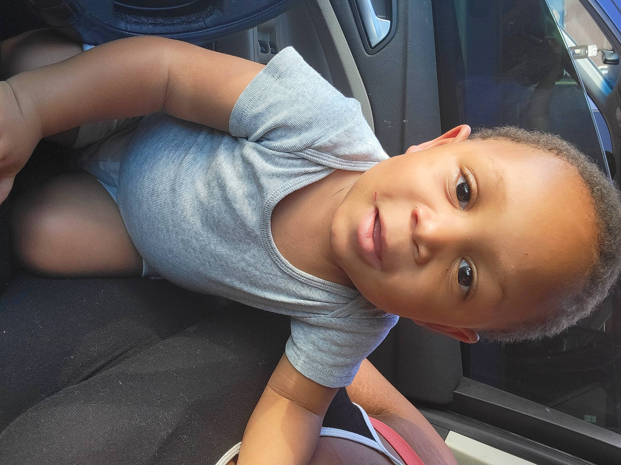 Gavin is registered to the contest to win money with this photo: auto_part, automotive_exterior, black_hair, child, comfort, cool, denim, dress, elbow, electric_blue, eye, flash_photography, human_leg, joint, knee, mouth, person, skin, thigh, vehicle_door