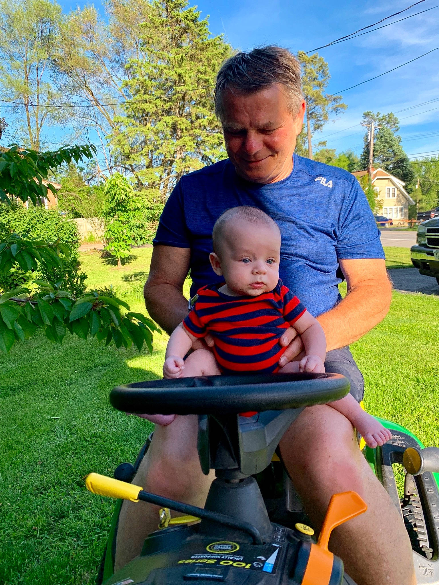 Caleb is registered to the contest to win money with this photo: baby, baby_products, child, father, fun, grass, joy, lap, lawn, leisure, male, person, plant, play, product, recreation, sitting, smile, summer, toddler