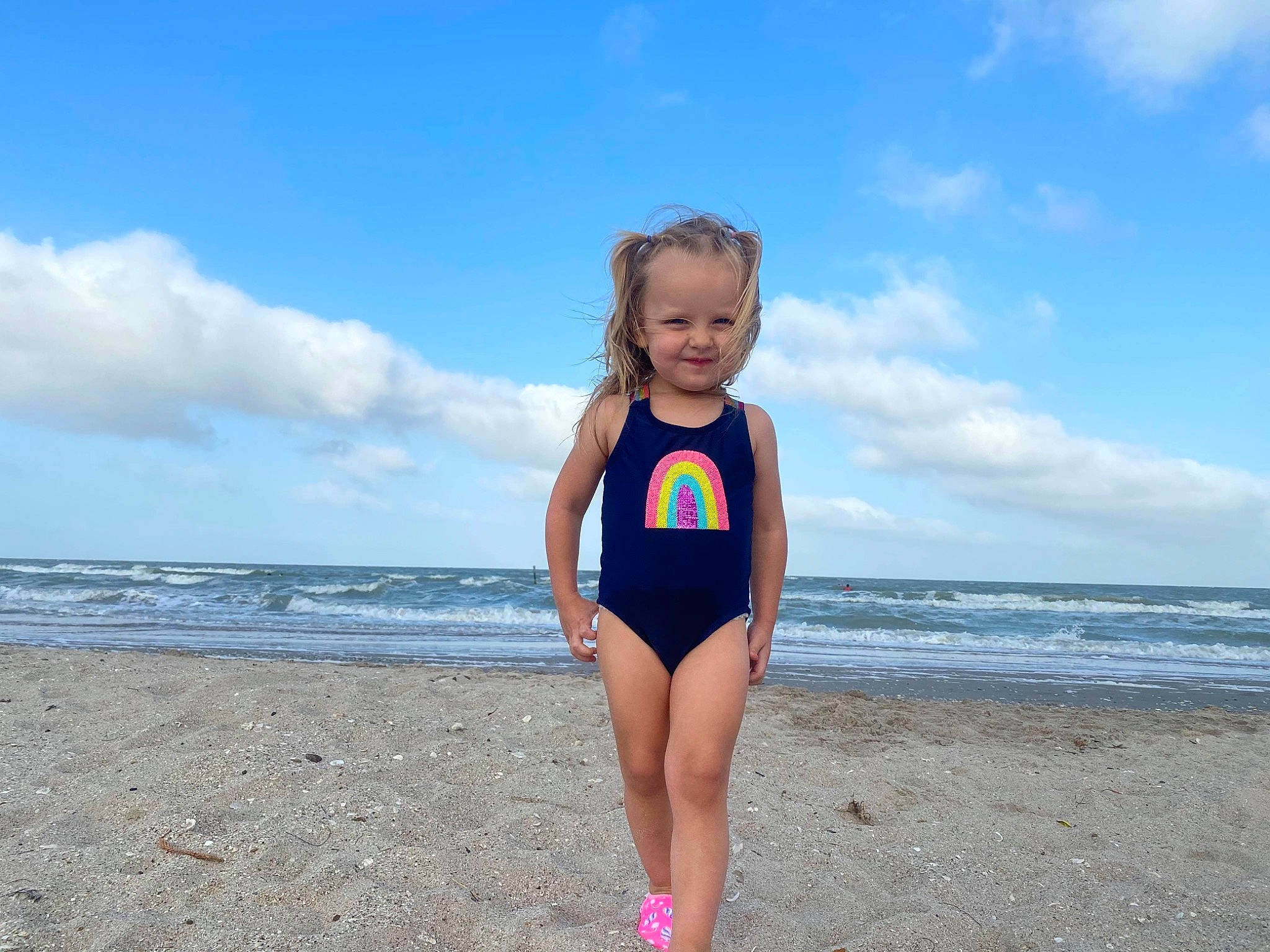 Brynnlee is registered to the contest to win money with this photo: azure, beach, cloud, fun, happy, horizon, joy, leg, leisure, leotard, one_piece_swimsuit, people_in_nature, people_on_beach, person, sky, smile, summer, swimwear, thigh, toddler