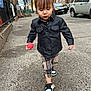 Alessia is registered to the contest to win money with this photo: toddler, child, leather_jacket, plaid_pants, red_ball, sidewalk, city, urban, street, cars, sneakers, trees, fall, walking, young_child, outdoor, person, daylight, casual, fashion