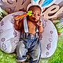 Jorel joined the competition — help win amazing prizes! baby, bunny_ears, toy_carrot, denim_jeans, suspenders, pillow, patterned_pillow, green_decoration, wooden_sign, indoor, child, cute, infant, bare_chest, feet, hand, face, headwear, relaxing, playful