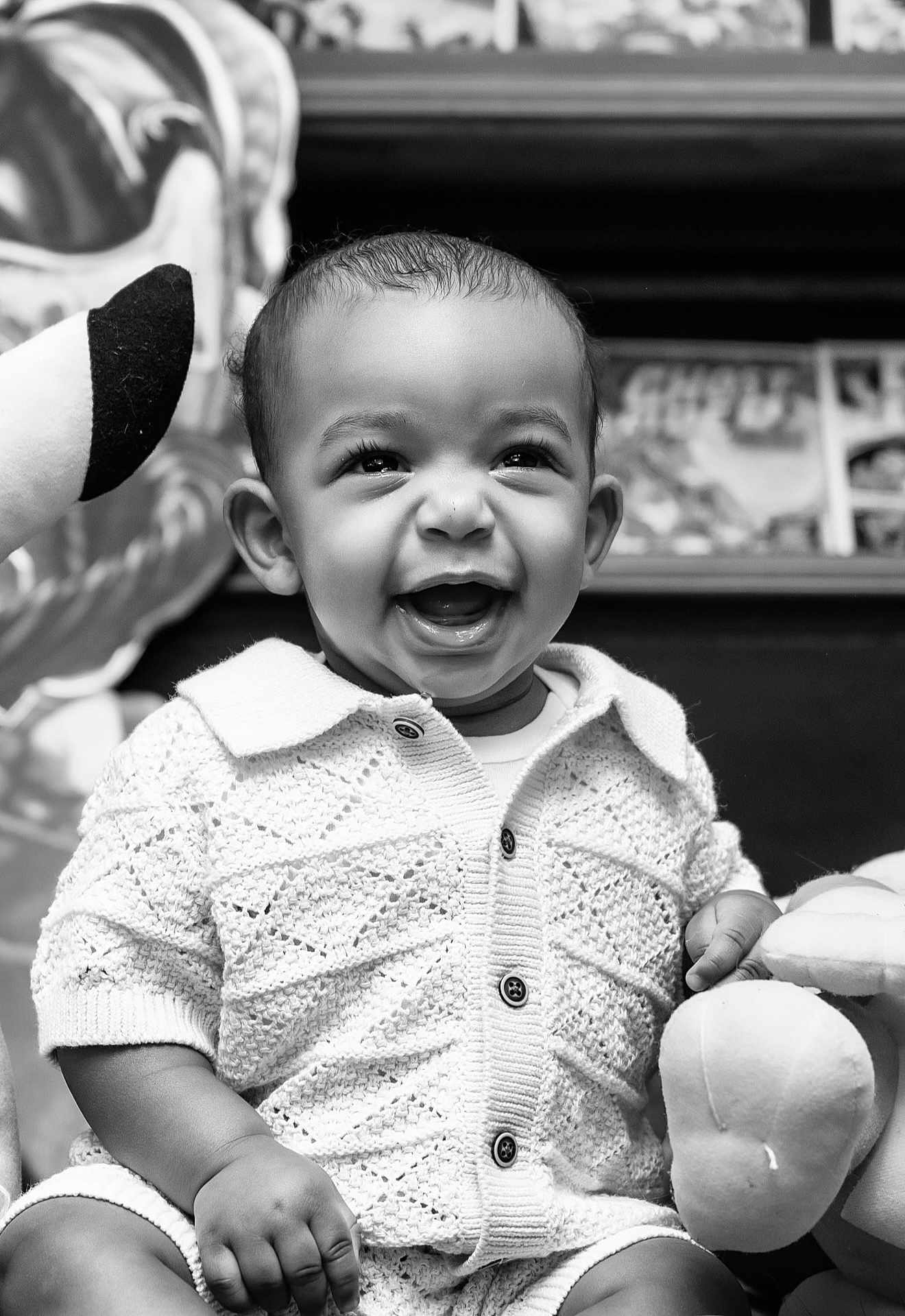 Jorel joined the competition — help win amazing prizes! baby, child, smiling, knitwear, plush_toy, black_and_white, portrait, happy, cute, indoor, closeup, infant, clothing, person, seated, short_hair, buttoned_shirt, toy, expression, face