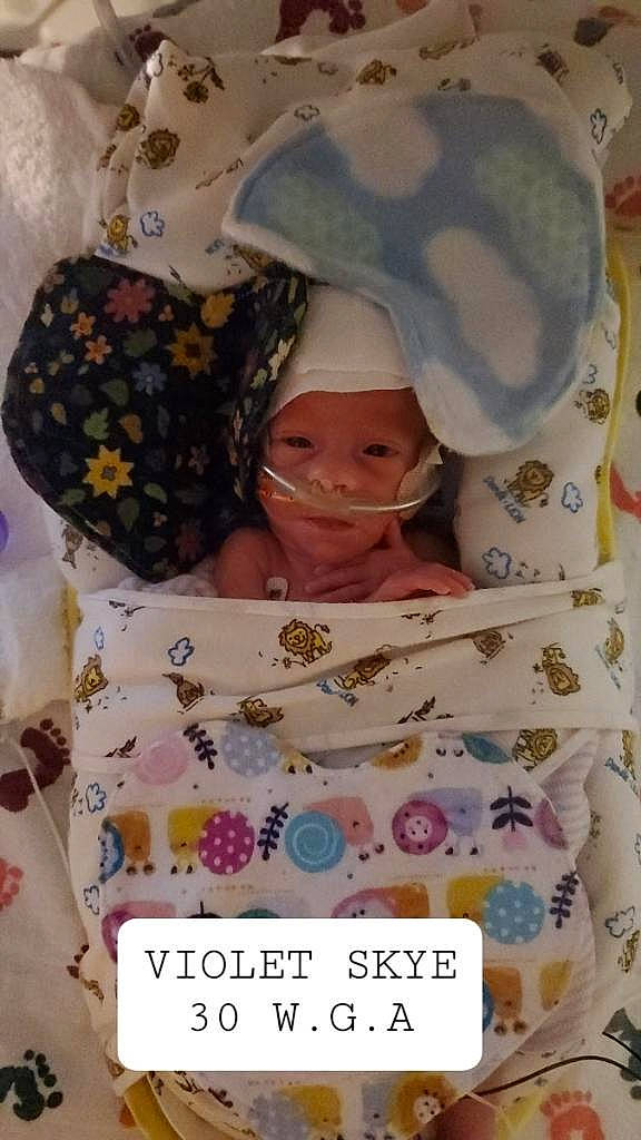 Violet is registered to the contest to win money with this photo: baby, baby_products, baby_sleeping, baby_toddler_clothing, beauty, bed, bedding, calendar, child, eyelash, font, happy, headwear, linens, pattern, person, pink, product, purple, room