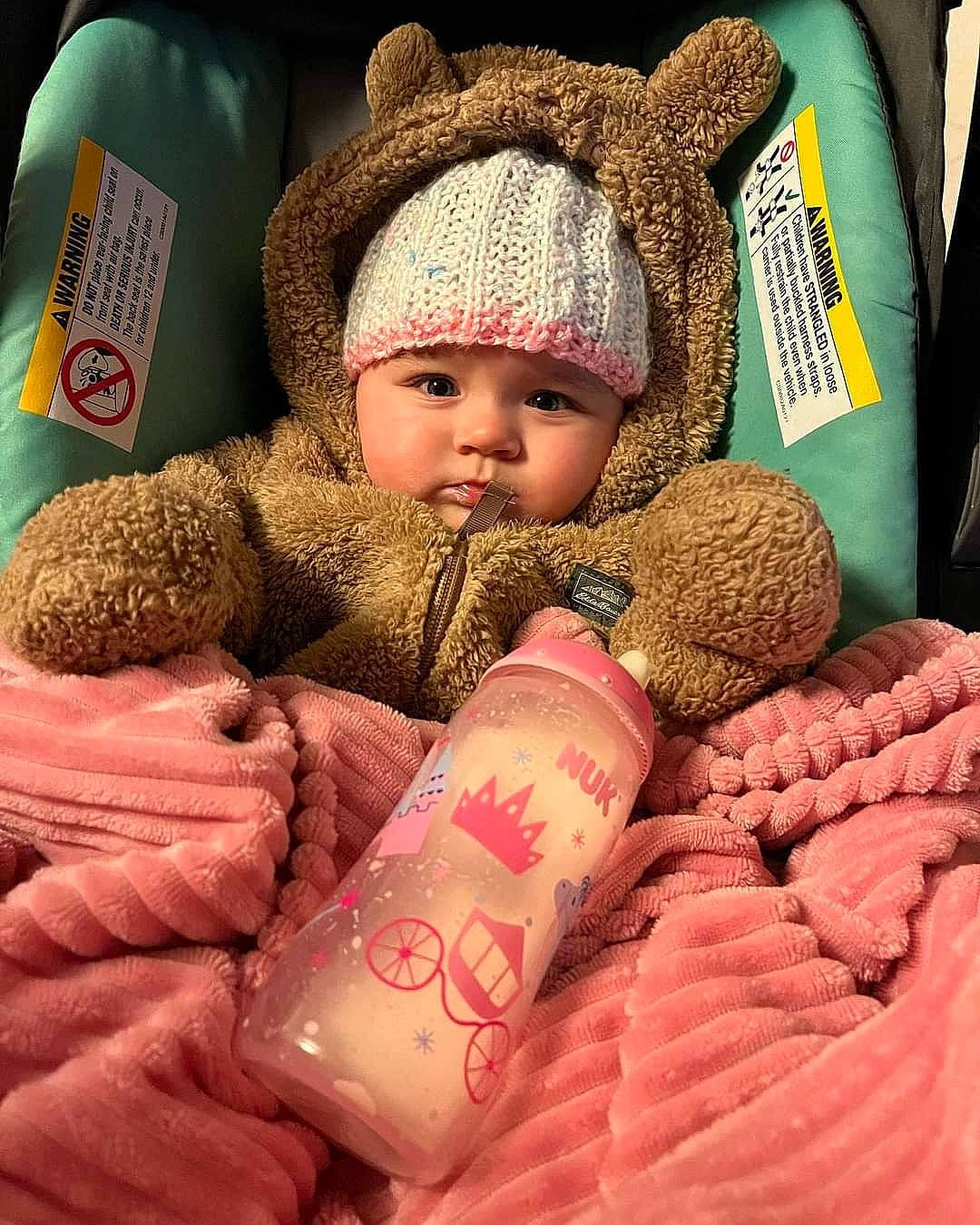 Aria Willow is registered to the contest to win money with this photo: baby, baby_sleeping, baby_toddler_clothing, cap, cheek, child, comfort, drinkware, hand, head, headwear, knit_cap, linens, lip, person, pink, skin, textile, thumb, toddler