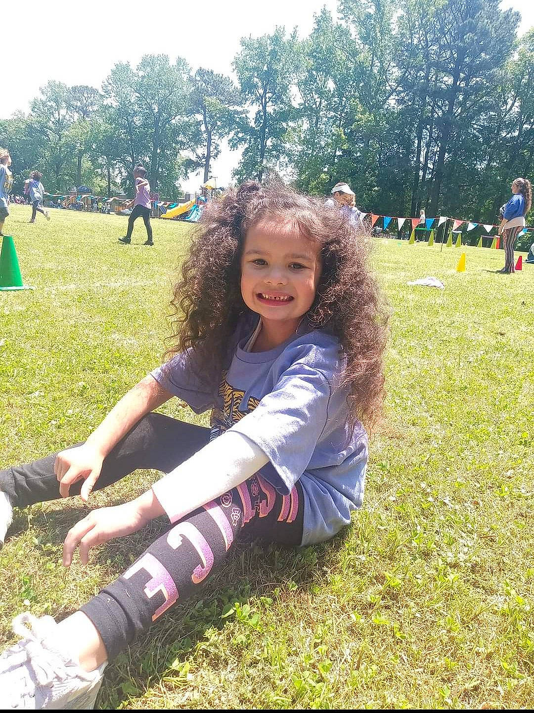 Maya is registered to the contest to win money with this photo: botany, brown_hair, fun, grass, grass_family, grassland, happy, joy, knee, leaf, leisure, meadow, people_in_nature, person, plant, recreation, shorts, sky, smile, summer