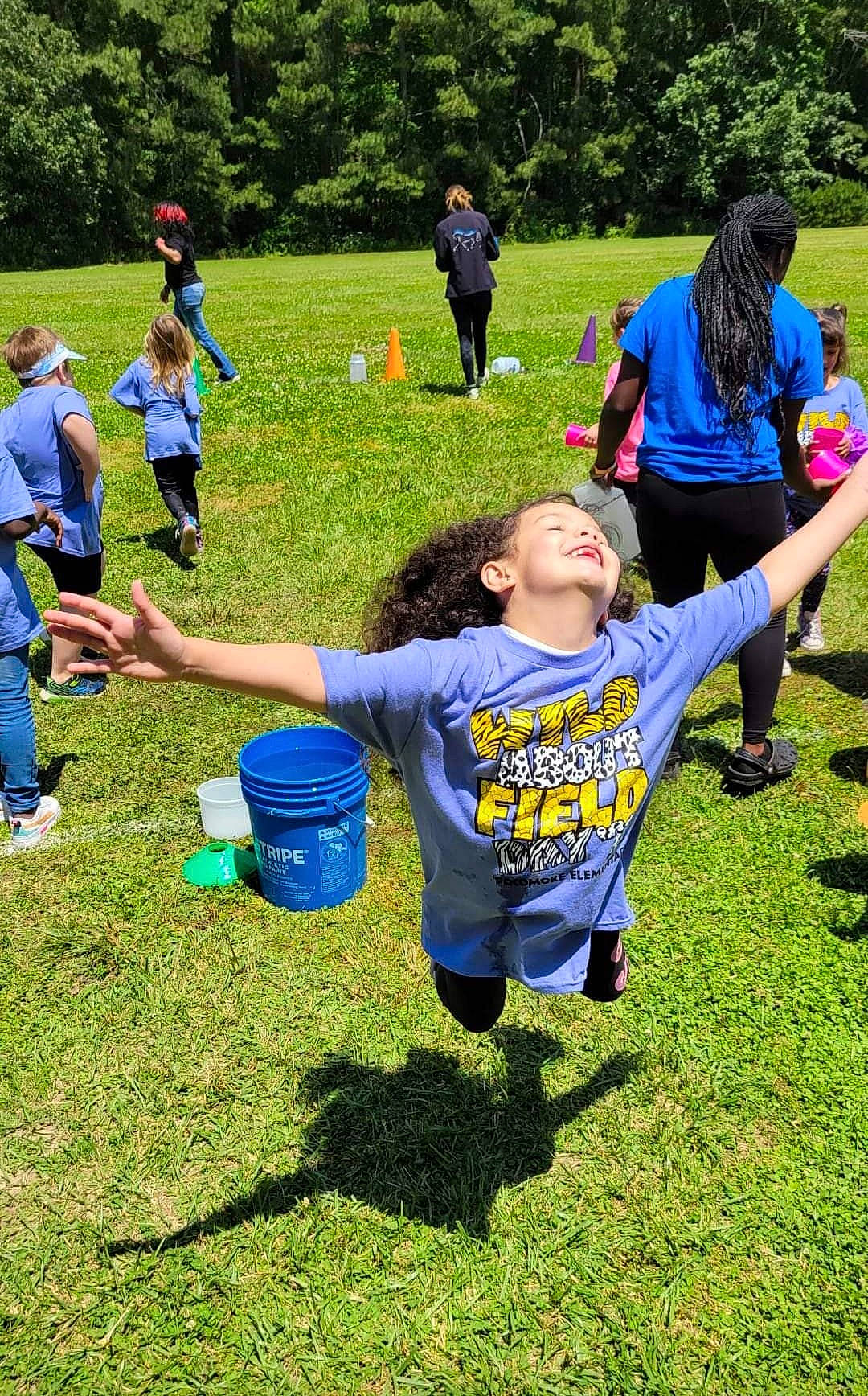 Maya is registered to the contest to win money with this photo: competition_event, event, fun, games, grass, grassland, green, groundcover, happy, lawn, leisure, people_in_nature, person, plant, play, player, recreation, shorts, t_shirt, team