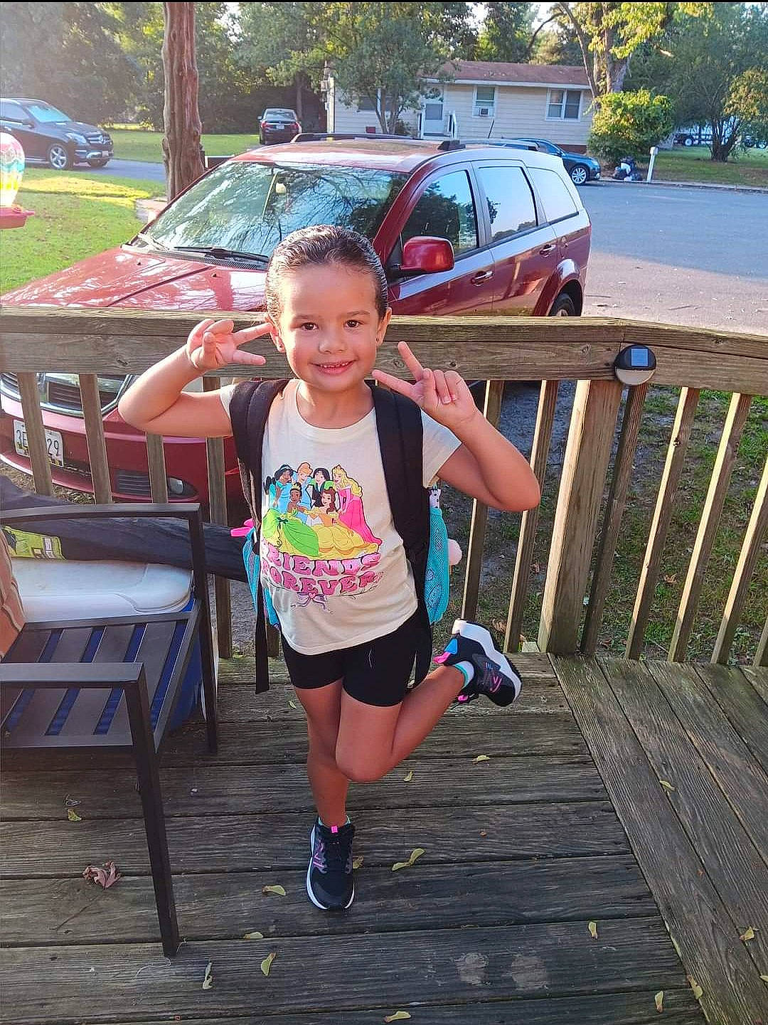 Maya joined the competition — help win amazing prizes! automotive_exterior, automotive_lighting, bumper, car, happy, human_leg, joy, leisure, motor_vehicle, person, public_space, recreation, shorts, smile, t_shirt, table, thigh, toddler, tree, vehicle