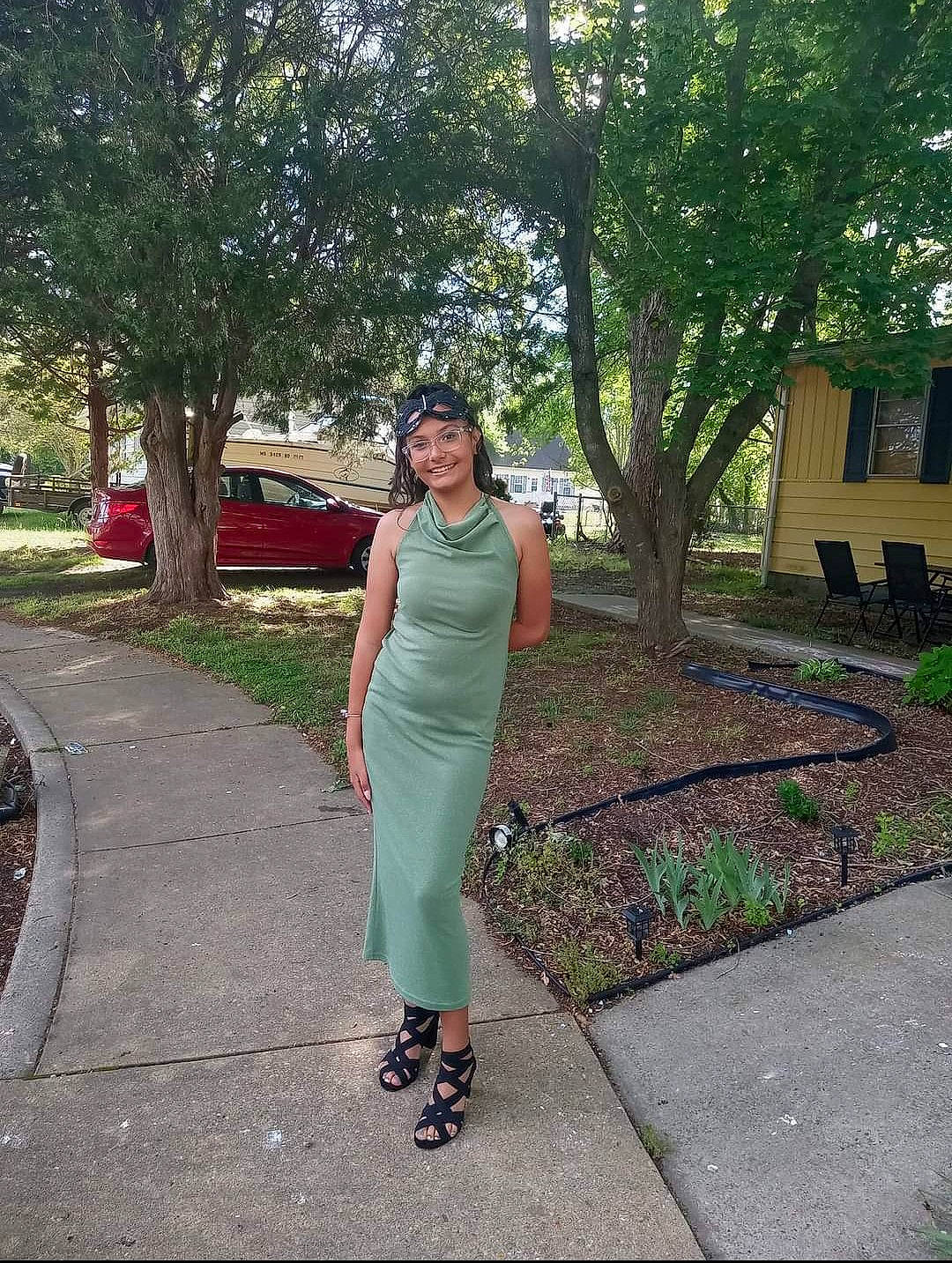 Desiree is registered to the contest to win money with this photo: asphalt, car, day_dress, dress, electric_blue, grass, headwear, human_leg, joy, leisure, one_piece_garment, person, plant, road, road_surface, sidewalk, sleeve, tints_and_shades, tire, tree