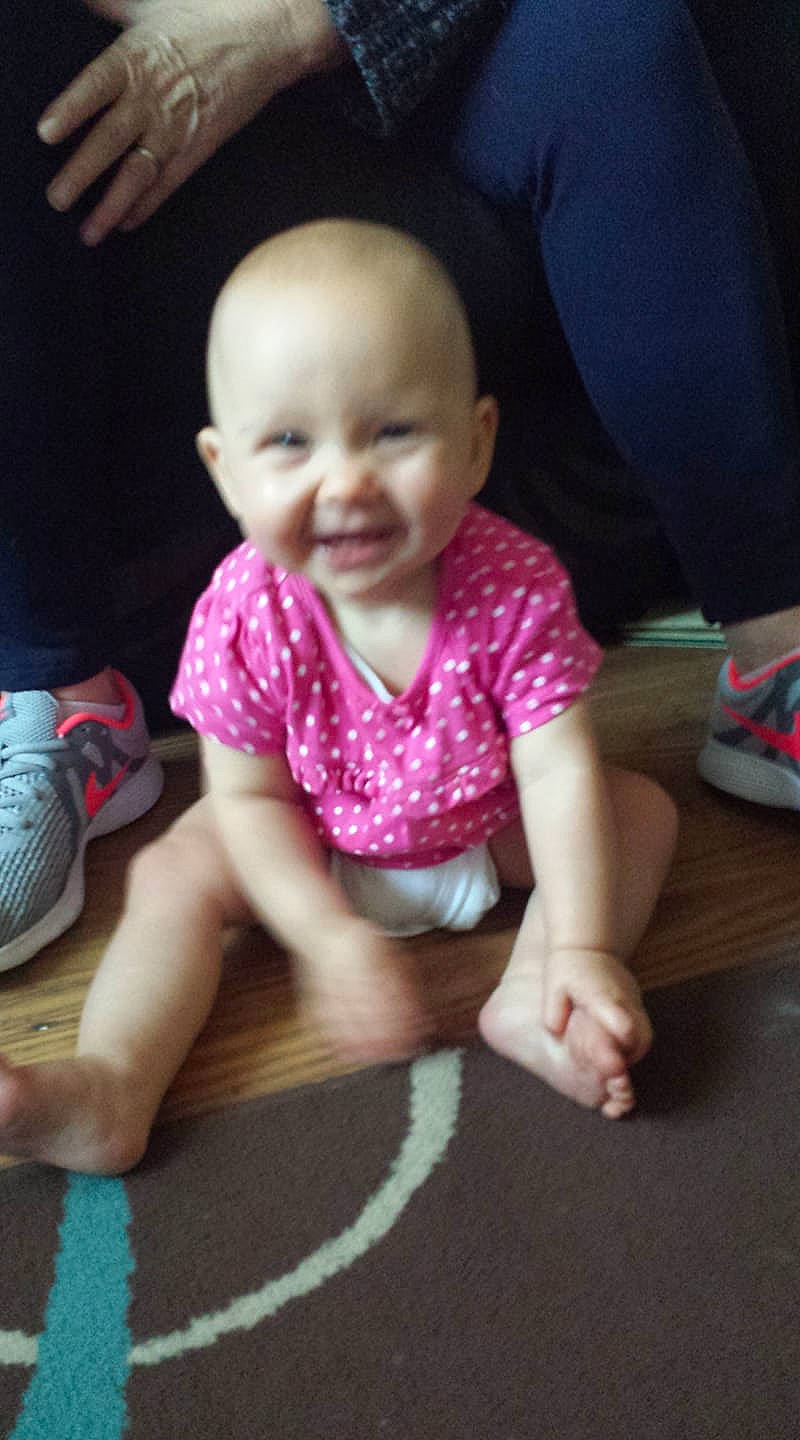 Kacey is registered to the contest to win money with this photo: arm, cheek, child, crawling, day, finger, fun, girl, hand, head, infant, joy, leg, mouth, person, pink, play, product, sitting, skin