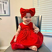 Elena is registered to the contest to win money with this photo: baby, child, red_dress, headband, bow, smile, happy, sitting, chair, indoor, cute, portrait, infant, clothing, feet, person, fashion, adorable, fun, bright