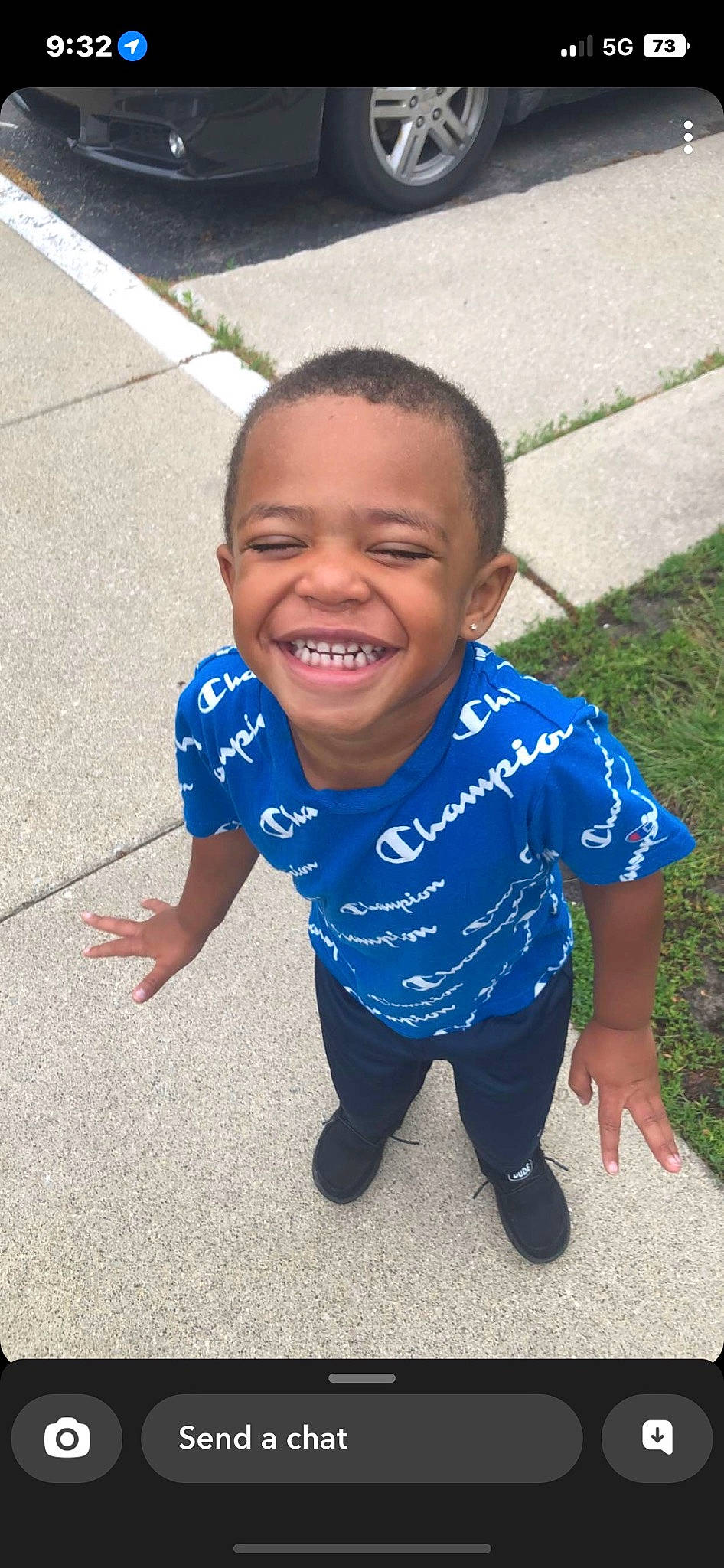 King is registered to the contest to win money with this photo: asphalt, baby_toddler_clothing, child, electric_blue, eye, flooring, fun, grass, happy, joy, leisure, nose, person, play, road_surface, sleeve, smile, soil, standing, t_shirt