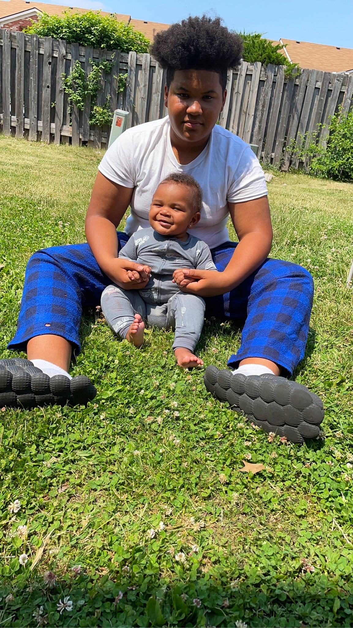 Kylen is registered to the contest to win money with this photo: baby, botany, fun, grass, grassland, green, groundcover, happy, joy, lawn, leaf, leisure, people_in_nature, person, plant, recreation, shoe, shorts, smile, sneakers