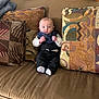 Camryn joined the competition — help win amazing prizes! baby, infant, couch, sofa, cushion, patterned_cushion, brown_couch, indoors, clothing, tuxedo, baby_clothes, sitting, face, head, small_fingers, white_socks, cute, portrait, furniture, home