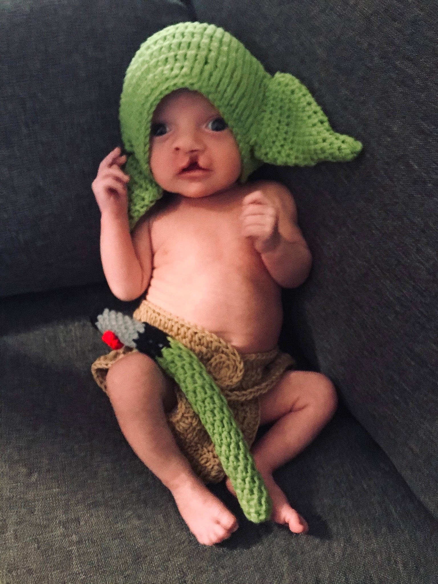 Gideon joined the competition — help win amazing prizes! arm, baby, baby_toddler_clothing, barefoot, cap, child, comfort, face, fashion_accessory, finger, foot, grass, headwear, human_leg, knit_cap, person, sitting, skin, thigh, thumb