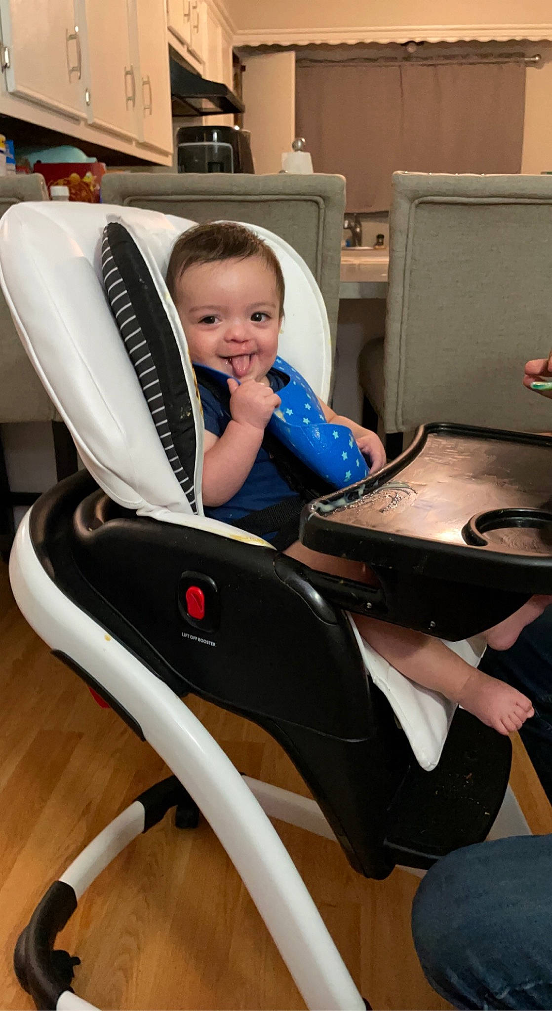 Gideon is registered to the contest to win money with this photo: automotive_design, baby, baby_carriage, baby_toddler_clothing, black, chair, child, comfort, electric_blue, fun, human_leg, joy, knee, lap, office_chair, person, room, sitting, smile, sneakers