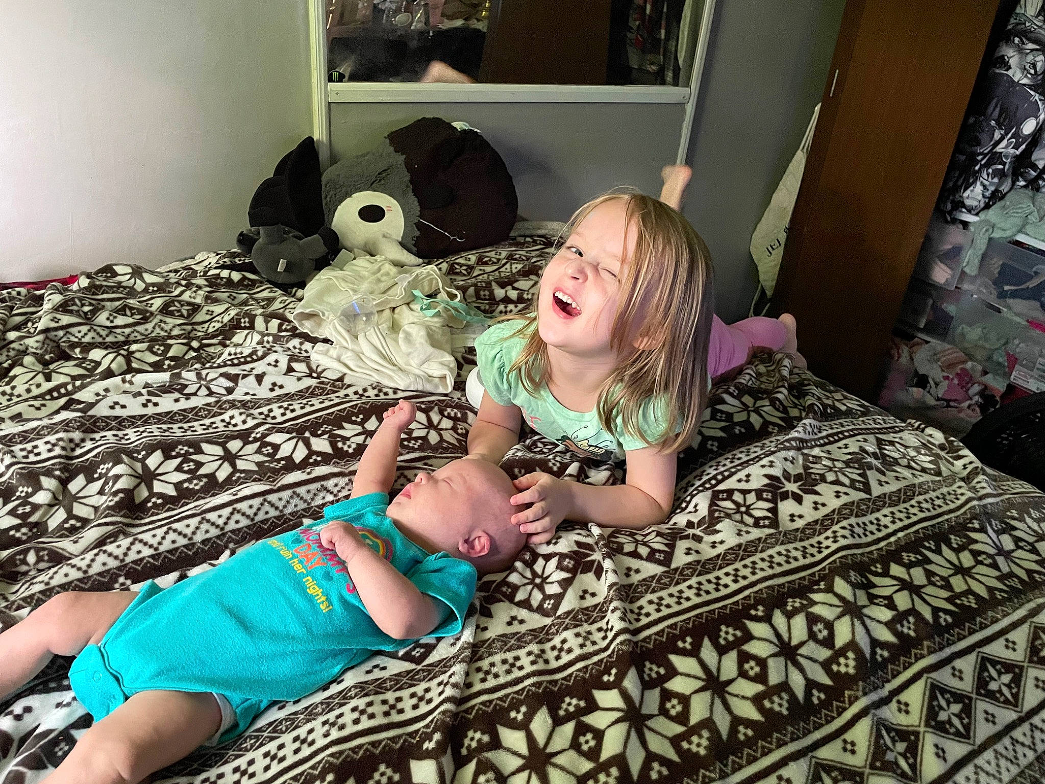 Jessie is registered to the contest to win money with this photo: bed, bedding, bedroom, child, comfort, cool, doll, fashion, fun, happy, human, human_leg, linens, living_room, pattern, person, sitting, t_shirt, textile, toddler