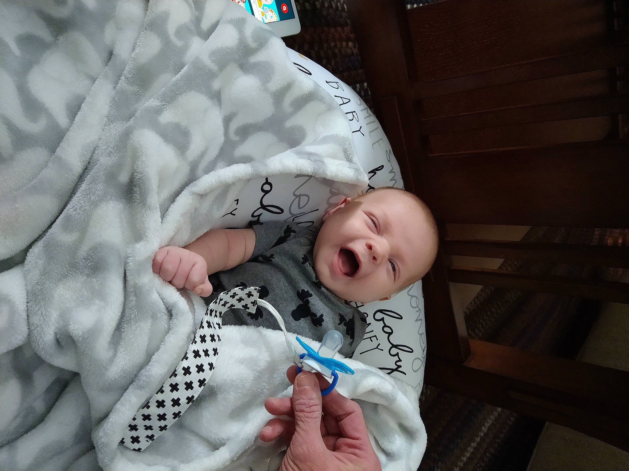 Konner is registered to the contest to win money with this photo: baby, baby_products, baby_toddler_clothing, blanket, child, comfort, finger, hand, human, linens, nail, person, product