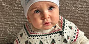 Stefan a rejoint le concours — aidez-le/la à gagner de superbes lots ! baby, blue_eyes, child, christmas_hat, cute, expression, face, festive_clothing, hands, holiday, indoors, knitwear, pattern, portrait, santa_hat, seated, soft_lighting, sweater, warm_clothing, winter