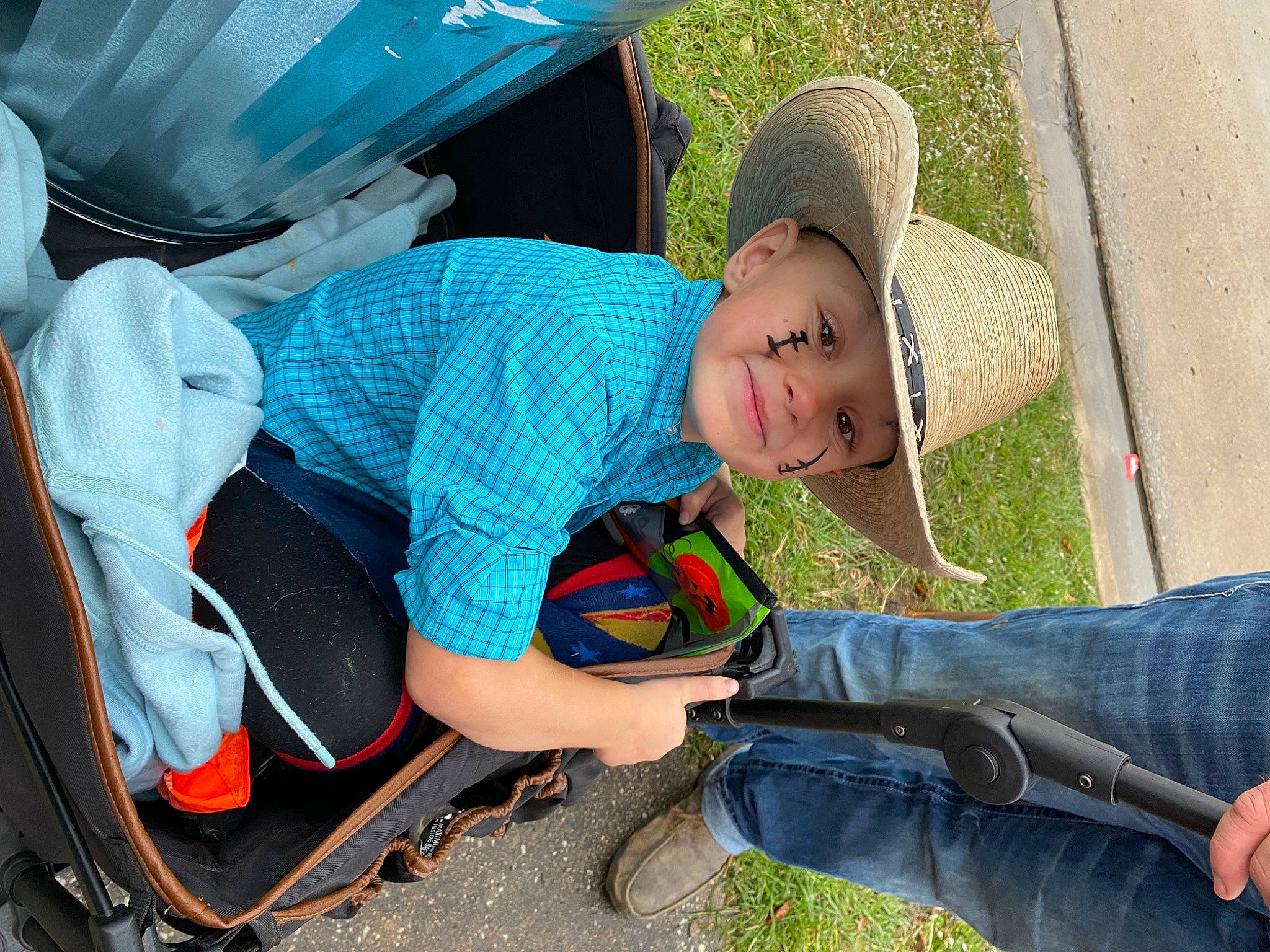 Jaxton joined the competition — help win amazing prizes! backpack, baseball_cap, child, electric_blue, fun, grass, hat, headwear, jeans, landscape, leisure, motor_vehicle, person, personal_protective_equipment, plant, recreation, shorts, sitting, sun_hat, toddler
