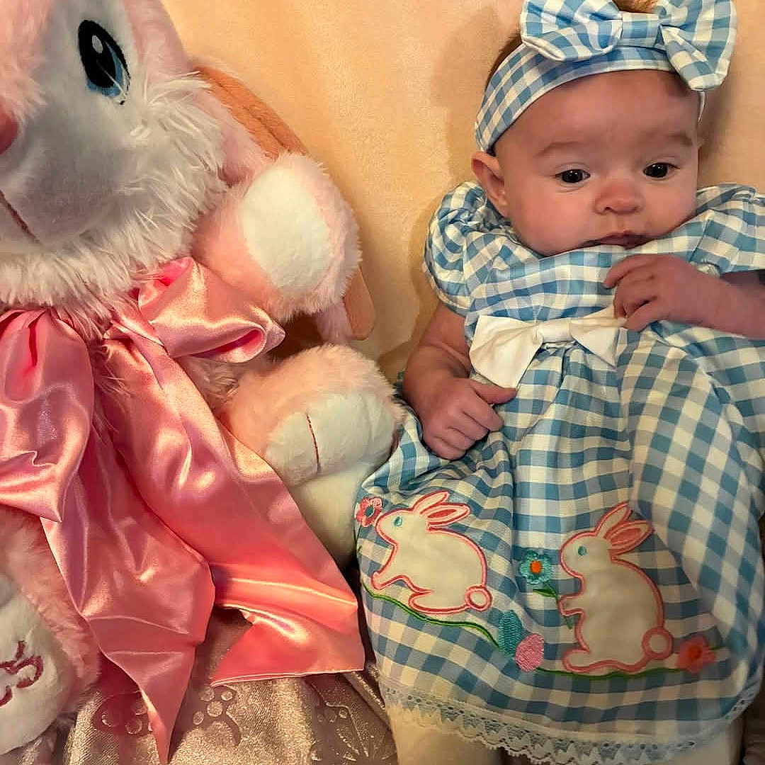 Sophia joined the competition — help win amazing prizes! baby, blanket, clothing, costume, couch, cushion, dress, face, furniture, hat, head, homedecor, newborn, people, person, photography, portrait, quilt, sitting, toy