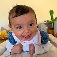 Penny joined the competition — help win amazing prizes! baby, smiling, face, infant, cute, happy, indoor, toddler, clothing, bib, polka_dots, hands, eyes, expression, cactus, background, table, pattern, skin, portrait