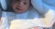Leilani joined the competition — help win amazing prizes! baby, infant, car_seat, blanket, bow, headband, smile, face, child, clothing, seatbelt, indoors, person, portrait, cute, newborn, soft, comfort, resting, young
