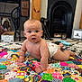 Carson joined the competition — help win amazing prizes! baby, diaper, colorful_quilt, patchwork, floor, carpet, fireplace, vintage, sewing_machine, table, statue, bulldog, home_interior, wooden_pillar, curious, child, indoor, person, face, crawling