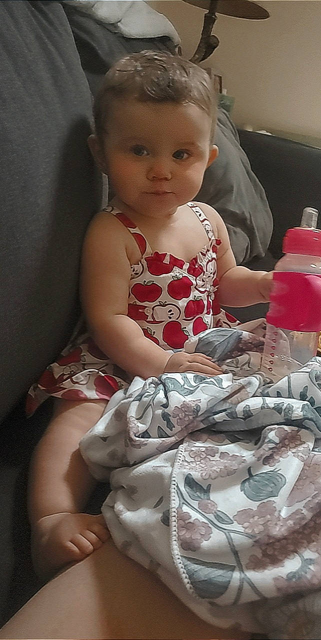 Abbigail is registered to the contest to win money with this photo: baby, baby_products, baby_toddler_clothing, beauty, blond, cheek, child, day_dress, flash_photography, hairstyle, human_leg, iris, pattern, person, pink, plastic, plastic_bottle, sitting, skin, toddler