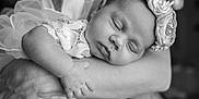 Alana is registered to the contest to win money with this photo: arm, baby, black_and_white, closeup, clothing, flower, hand, headband, human, infant, lace, newborn, peaceful, person, portrait, rest, skin, sleeping, soft, tenderness