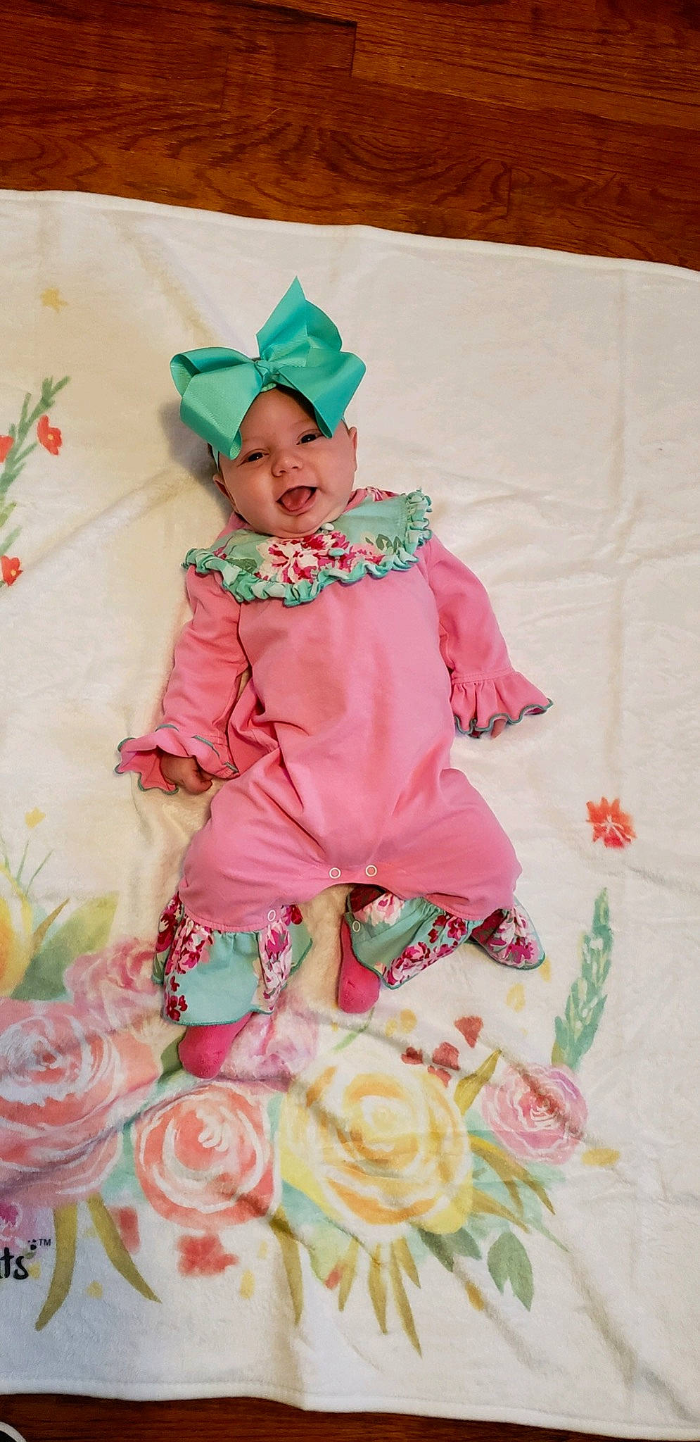 Blakelynn is registered to the contest to win money with this photo: baby, baby_products, baby_toddler_clothing, child, costume, flower, pattern, peach, person, pink, plant, product, rose, ruffle, sleeve, textile, toddler