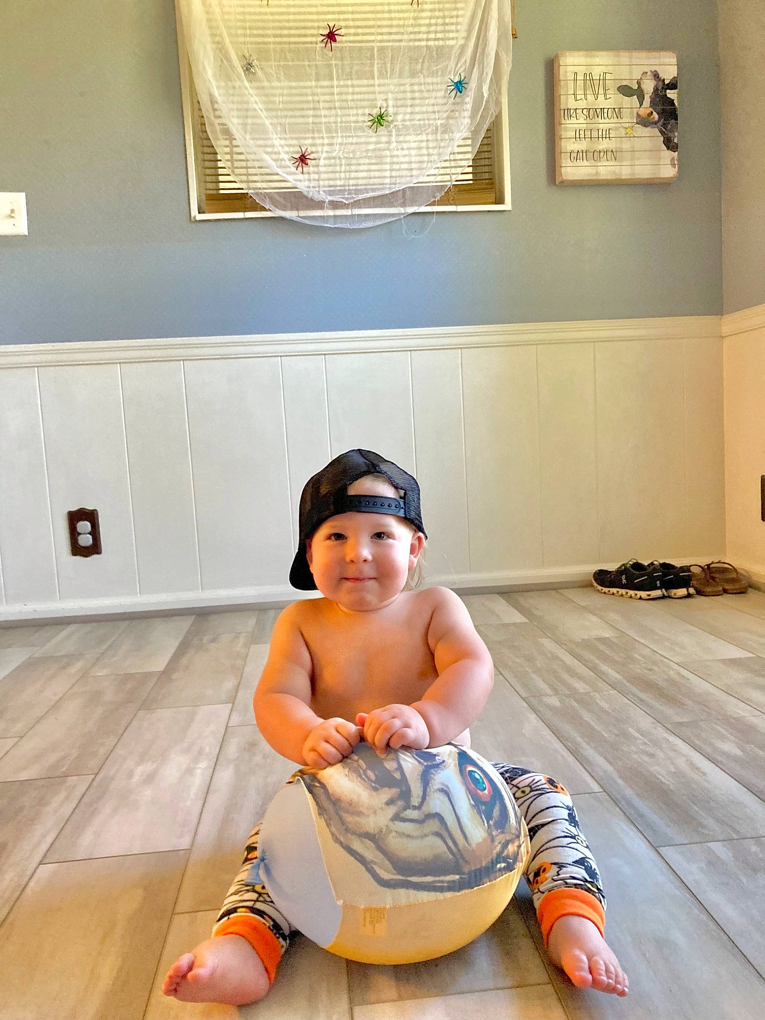 Harlan is registered to the contest to win money with this photo: baby, baby_toddler_clothing, barefoot, cabinetry, comfort, floor, flooring, foot, hardwood, headwear, human_leg, interior_design, joy, knee, laminate_flooring, leisure, person, shoulder, thigh, toddler