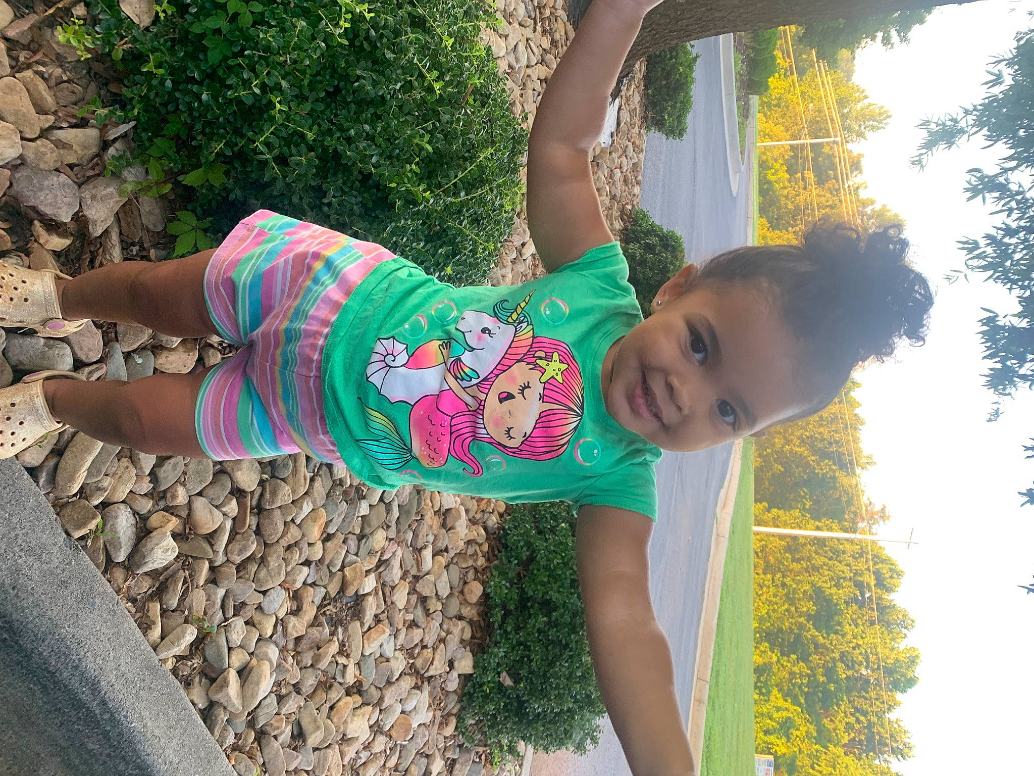 Ashlyn is registered to the contest to win money with this photo: arm, child, cool, face, fun, grass, hair, happy, human_body, joint, joy, leisure, people_in_nature, person, plant, recreation, shoulder, sky, smile, t_shirt