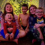 Kolt joined the competition — help win amazing prizes! child, children, smiling, laughing, christmas_tree, holiday, pajamas, barefoot, indoors, family, festive, decorations, happy, toddler, boy, girl, glasses, floor, seated, warm_lighting