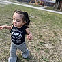toddler, child, girl, pigtails, grass, playground, shirt, pants, outdoor, walking, happy, young_child, casual_clothing, daylight, nature, cute, smiling, person, park, blurred_background