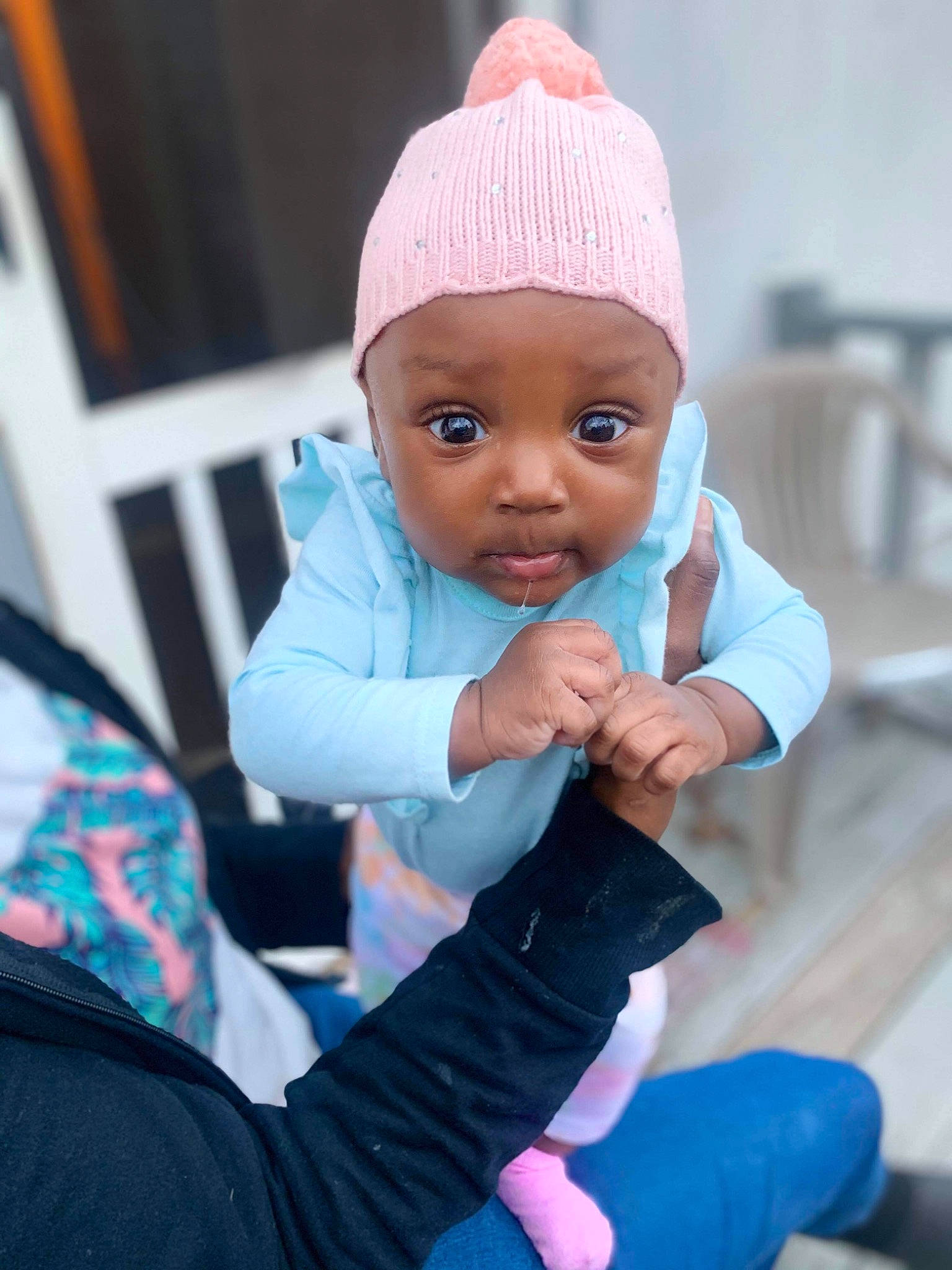 Sariyah is registered to the contest to win money with this photo: baby, baby_toddler_clothing, cap, child, electric_blue, event, fashion_accessory, fun, gesture, happy, knit_cap, leisure, magenta, outerwear, person, pink, purple, sitting, skin, toddler