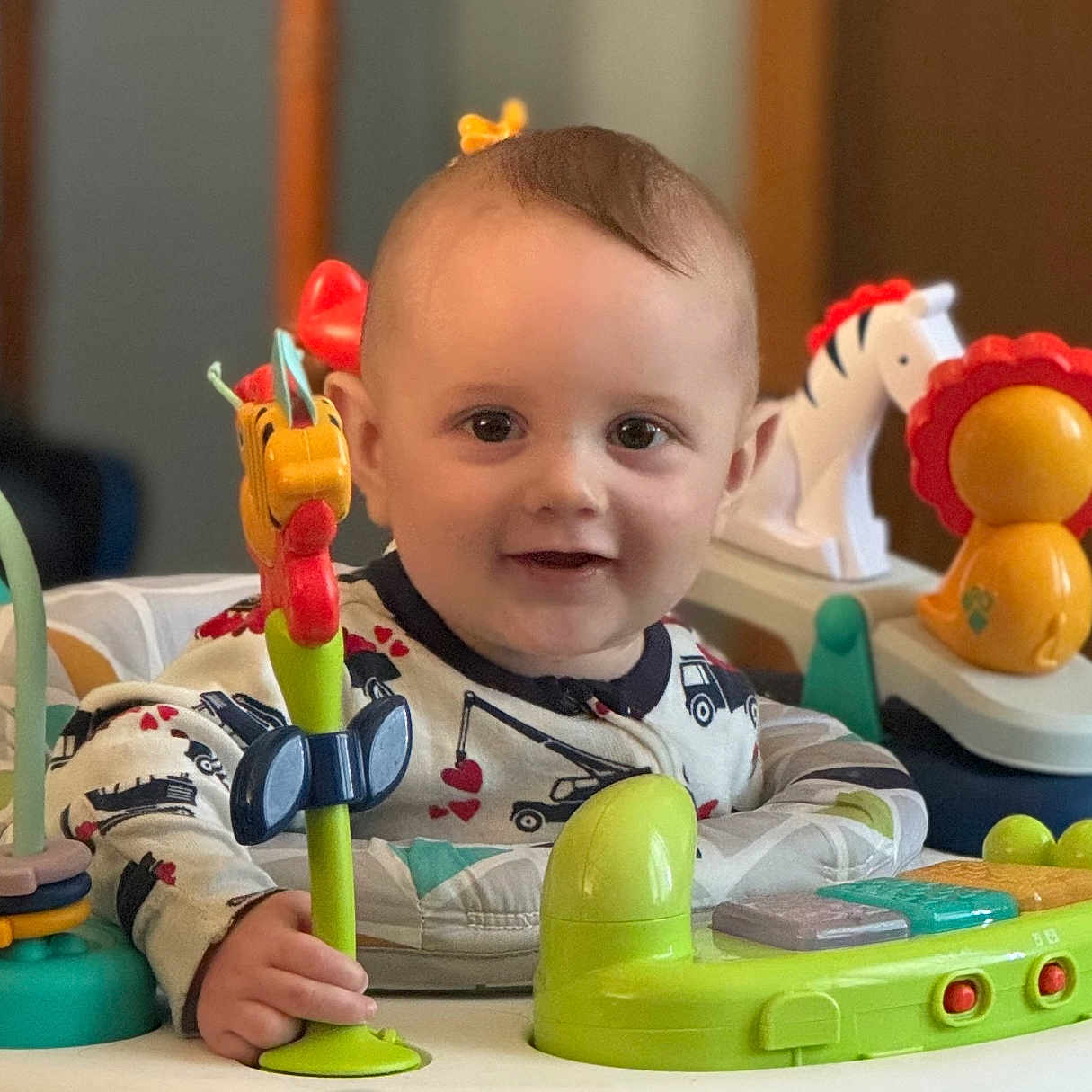 Caspian is registered to the contest to win money with this photo: baby, bodypart, cream, cutlery, dessert, face, finger, hand, happy, head, indoors, interiordesign, person, photography, playarea, portrait, sitting, smile, spoon, toy