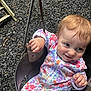 Emberlynn is registered to the contest to win money with this photo: baby, child, swing, playground, floral_clothing, smile, outdoor, play, infant, happy, seat, hand, metal_chain, ground, person, cute, fun, young_child, daylight, expression