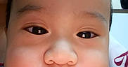 Zyron joined the competition — help win amazing prizes! baby, child, infant, face, portrait, close_up, indoors, striped_clothing, tongue, eyes, nose, mouth, cheeks, serious_expression, candid, person, head, clothing, background, photograph