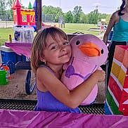 Alexa is registered to the contest to win money with this photo: birthday, bounce_house, celebration, child, family, fun, gift_bag, girl, happy, outdoor, park, party, picnic_table, pink_duck, playground, plush_toy, purple_dress, smiling, summer, toy