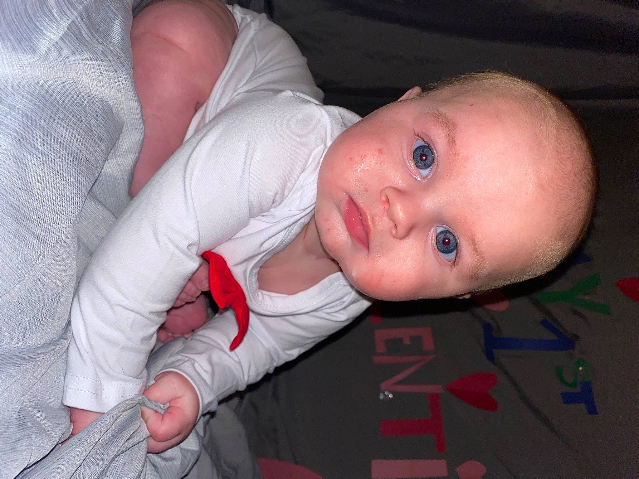 Bentley is registered to the contest to win money with this photo: baby, baby_products, baby_toddler_clothing, cheek, child, comfort, elbow, eye, eyebrow, finger, flooring, fun, gesture, iris, lip, mouth, nose, person, skin, sleeve