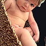 Scotlynne is registered to the contest to win money with this photo: baby, infant, child, headband, bow, blue_eyes, basket, woven, curious, skin, naked, cute, portrait, sitting, soft_light, expression, young, human, indoors, closeup