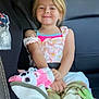 Harley is registered to the contest to win money with this photo: car, car_interior, carseat, child, clothing, cushion, dress, face, female, furniture, girl, head, homedecor, person, photography, portrait, shorts, t_shirt, transportation, vehicle