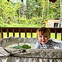 Niko joined the competition — help win amazing prizes! baby, child, playpen, outdoor, porch, wood, nature, greenery, trees, shed, grass, smiling, face, person, infant, striped_clothing, daylight, cute, young_child, happy