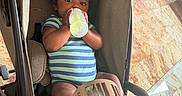 Dalton is registered to the contest to win money with this photo: baby, baby_fan, bottle, carpet, child, comfort, cute, face, fan, footwear, glass_table, hand, indoor, infant, onesie, person, relaxing, seated, striped_clothing, stroller